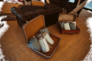 5 blankets in a vintage suitcase